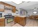 Kitchen features wood cabinets, stainless steel appliances, and an adjacent dining area at 4736 W Marconi Ave, Glendale, AZ 85306