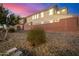 Rear view of house at dusk, showing rock landscaping at 4746 S Ferric --, Mesa, AZ 85212