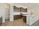 Spacious kitchen featuring dark wood cabinets, white countertops, and a large island at 5515 N 193Rd Ave, Litchfield Park, AZ 85340