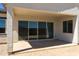 Covered patio with sliding glass doors leading to backyard at 5515 N 193Rd Ave, Litchfield Park, AZ 85340