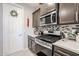 Kitchen with stainless steel stove and microwave at 613 N 108Th Ave, Avondale, AZ 85323