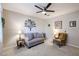 Relaxing sitting area featuring a loveseat and armchair with ceiling fan at 613 N 108Th Ave, Avondale, AZ 85323