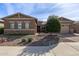 House exterior with tan colored walls, stone accents, and desert landscaping at 6509 W Hunter Ct, Phoenix, AZ 85083