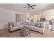 Bright living room featuring a large sectional sofa and tile floors at 6509 W Hunter Ct, Phoenix, AZ 85083