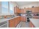 Kitchen features stainless steel appliances and light wood cabinets at 7407 W Tether Trl, Peoria, AZ 85383