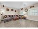 Living Room with L-shaped sectional and wood-look flooring at 7407 W Tether Trl, Peoria, AZ 85383