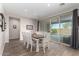 Bright dining room with a large table and chairs, sliding glass doors to backyard pool at 7718 W Raymond St, Phoenix, AZ 85043