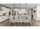 Modern kitchen featuring white cabinets, granite countertops, and island with seating at 7718 W Raymond St, Phoenix, AZ 85043