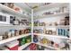 Well-stocked pantry with ample shelving for storage at 7718 W Raymond St, Phoenix, AZ 85043