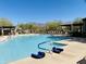 Inviting community pool with expansive deck and mountain views at 8083 E Autumn Sage Trl, Gold Canyon, AZ 85118