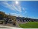 View of community green space and homes on a sunny day at 9505 E Silo Cir, Florence, AZ 85132