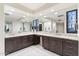 Luxurious bathroom with double vanity, large mirror, and walk-in shower at 10384 E Loving Tree Ln, Scottsdale, AZ 85262