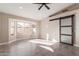 Bedroom with sliding barn door and bay window at 10749 W Tonopah Dr, Sun City, AZ 85373