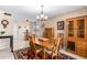 Well-lit dining room featuring a wood table and hutch at 12822 W Prospect Dr, Sun City West, AZ 85375