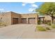 Tan stucco home with three-car garage and desert landscaping at 13300 E Via Linda St # 1038, Scottsdale, AZ 85259