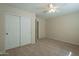 Well-lit bedroom with double door closet and ceiling fan at 13478 W Statler St, Surprise, AZ 85374