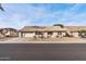 Ranch-style home with a two-car garage and desert landscaping at 15008 W Greystone Dr, Sun City West, AZ 85375