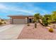 One-story house with a two-car garage and desert landscaping at 17770 W Calistoga Dr, Surprise, AZ 85387