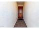 Front entry with a dark wood door and tile flooring at 18035 W Muirwood Dr, Goodyear, AZ 85338