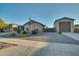 House exterior with a three-car garage and American flag at 21999 E Camacho Rd, Queen Creek, AZ 85142