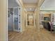 Long hallway with tile floors and access to other rooms at 21999 E Camacho Rd, Queen Creek, AZ 85142