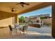 Covered patio with seating area and ceiling fans at 21999 E Camacho Rd, Queen Creek, AZ 85142