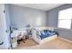 Charming bedroom featuring a daybed, a vanity desk, and ample natural light at 2213 N Park Meadows Dr, Buckeye, AZ 85396