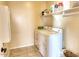 Laundry room with washer, dryer, and shelving at 2213 N Park Meadows Dr, Buckeye, AZ 85396