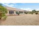 Large backyard with gravel landscaping and a sunroom at 22418 N Mirage Ln, Sun City West, AZ 85375