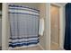 Bathroom with shower and striped shower curtain at 298 S 18Th St, Coolidge, AZ 85128