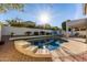 Inviting backyard with a kidney shaped pool and patio furniture at 3495 E Riopelle Ave, Gilbert, AZ 85298