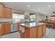 Kitchen with granite countertops, wooden cabinets, and an island at 3686 E Kimball Rd, Gilbert, AZ 85297