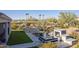 Landscaped backyard with outdoor kitchen and fireplace at 4414 W Jacaranda Dr, Eloy, AZ 85131