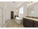 Elegant bathroom with soaking tub, double vanity, and walk-in shower at 5532 N 192Nd Ln, Litchfield Park, AZ 85340