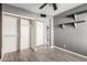 Well-lit bedroom with wood-look floors and built-in shelving at 5539 W Charleston Ave, Glendale, AZ 85308