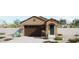 Tan stucco house with dark brown garage door, teal front door, and desert landscaping at 5656 N 205Th Ln, Buckeye, AZ 85396