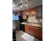 Modern kitchen features stainless steel appliances and wood cabinets at 6125 E Indian School Rd # 164, Scottsdale, AZ 85251