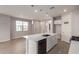 Modern kitchen with white cabinets, quartz countertops, and island at 678 N Bay Dr, Gilbert, AZ 85233