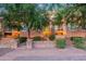 Building exterior with landscaping and walkway at dusk at 6940 E Cochise Rd # 1007, Paradise Valley, AZ 85253