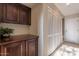 Laundry room with dark wood cabinets and plenty of storage at 6940 E Cochise Rd # 1007, Paradise Valley, AZ 85253