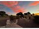 Relaxing backyard with seating area and fire pit, enjoying sunset views at 713 S 81St Pl, Mesa, AZ 85208