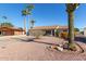 Single-story home with a light-grey exterior, two-car garage, and desert landscaping at 713 S 81St Pl, Mesa, AZ 85208