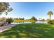 Serene pond view with lush landscaping and fountain at 713 S 81St Pl, Mesa, AZ 85208