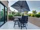 Private patio with table, chairs, and umbrella at 7272 E Gainey Ranch Rd # 51, Scottsdale, AZ 85258