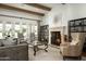 Living room with fireplace, hardwood floors, and high ceilings at 7543 N Mockingbird Ln, Paradise Valley, AZ 85253