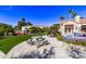 Landscaped backyard with a patio table and putting green at 9840 N 111Th Pl, Scottsdale, AZ 85259
