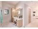 Vanity area with lighted mirror and ample storage at 9840 N 111Th Pl, Scottsdale, AZ 85259