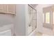Bathroom with a shower/tub combo and glass sliding doors at 9840 N 111Th Pl, Scottsdale, AZ 85259