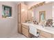 Vanity with a large mirror and a stained glass window at 9840 N 111Th Pl, Scottsdale, AZ 85259