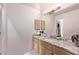 Bathroom with granite countertop, double sinks, and light wood cabinets at 9840 N 111Th Pl, Scottsdale, AZ 85259